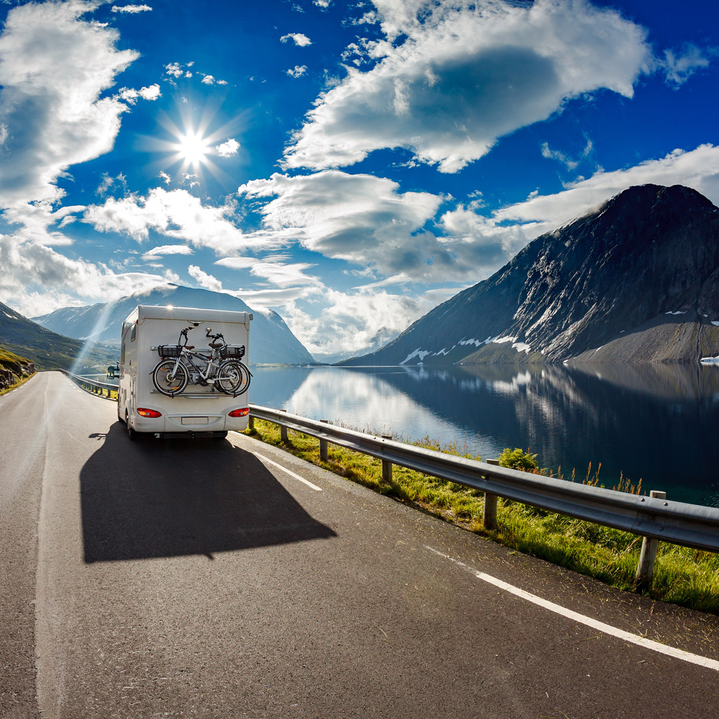 RV on the road on a sunny day, Assure suite for property and casualty | DXC Technology