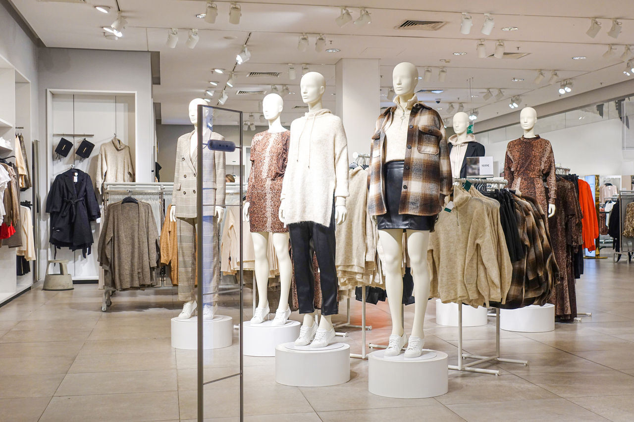 Modern fashionable brand interior of clothing store inside shopping center.