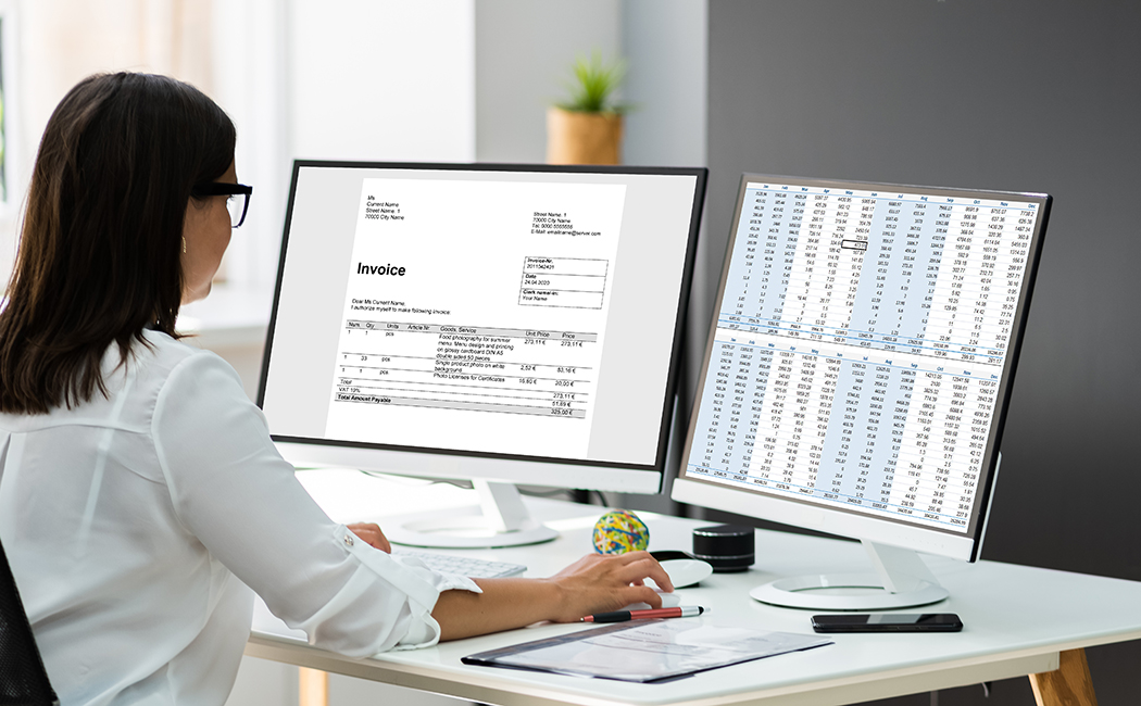 woman working on two monitors, Salesforce | DXC Technology