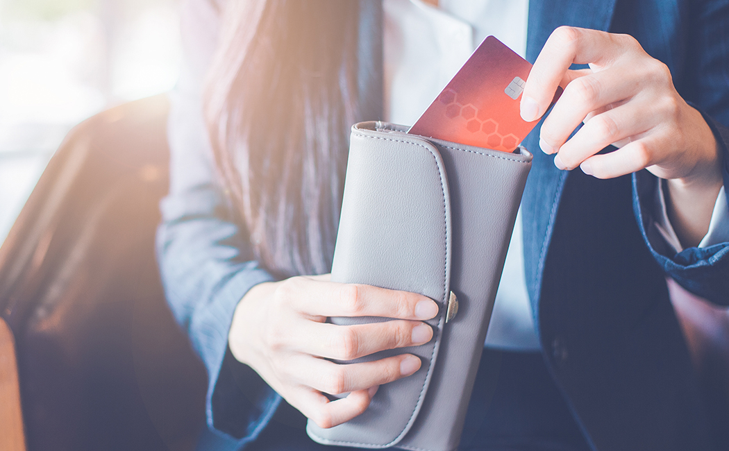 hands with credit card and wallet, Card issuing | DXC Technology