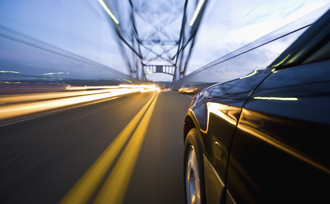 Car Speeding along Busy Bridge, Business process services: Property and casualty | DXC Technology