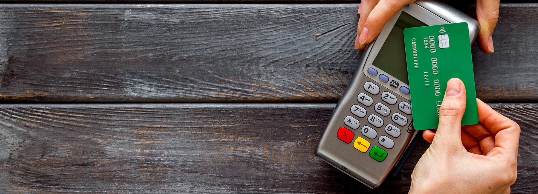 hands with credit card machine, Banking BPS, Merchant acquiring | DXC Technology