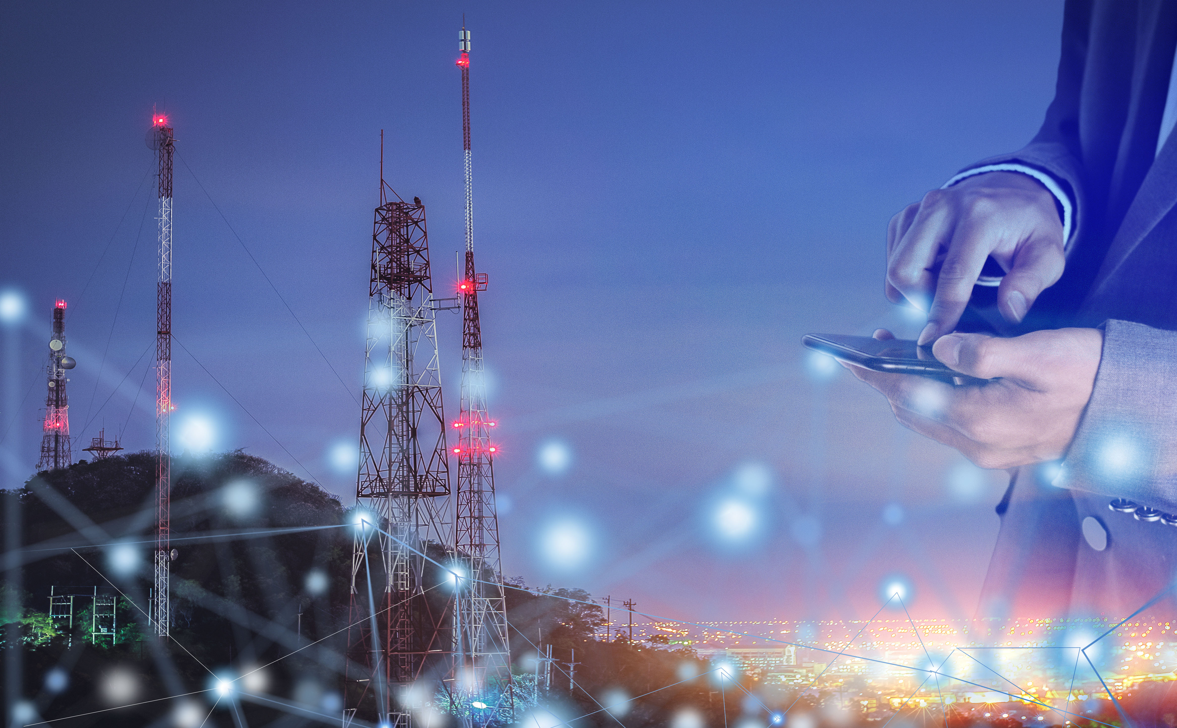 man on mobile phone, cellular towers in background, Technology, Media & Telecommunications | DXC Technology 