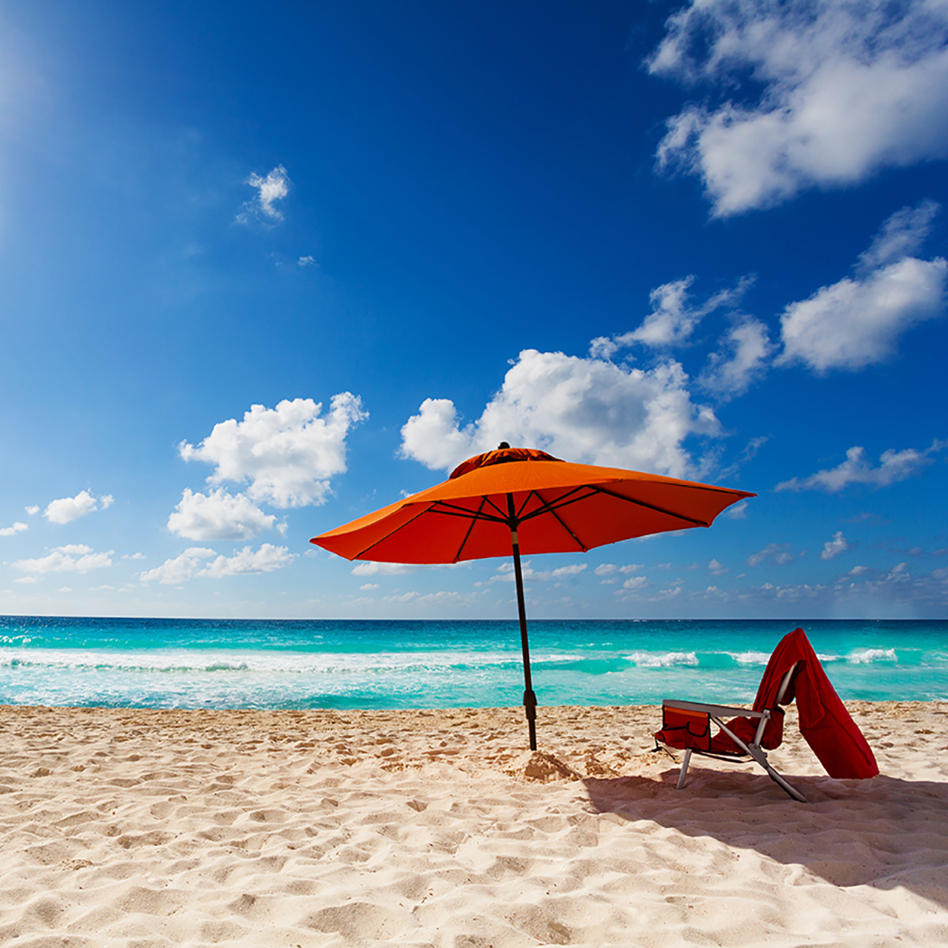 orange beach umbrella on beach, Insurance software | DXC Technology