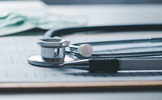 Stethoscope and pen resting on clipboard, Applications, Healthcare, Royal Adelaide Hospital | DXC Technology Customer Story