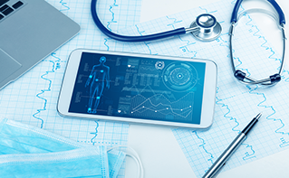 Tablet, stethoscope and pen laying on table with medical data charts, Cloud, Healthcare | DXC Technology Insights