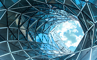 Modern glass structure with sky, modernizing insurance IT, Assure Reinsurance | DXC Technology Insights