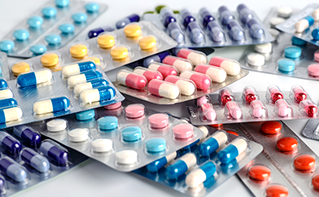 Multicolored pills in blister packets, Data & AI, Healthcare, Singapore General Hospital | DXC Technology Insights